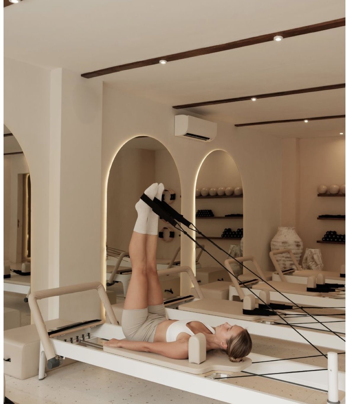 Professional reformer pilates session in a high-end Fayetteville wellness center highlighting boutique fitness services.
